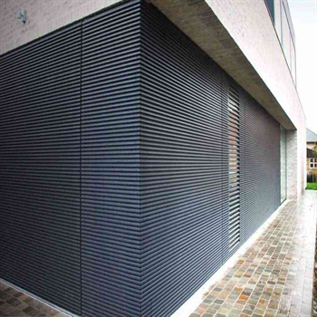 close up of the corner of a home covered with sleek horizontal louvred cladding in black
