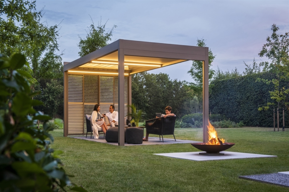 beige louvred pergola with led lighting strips in the backyard with a firepit