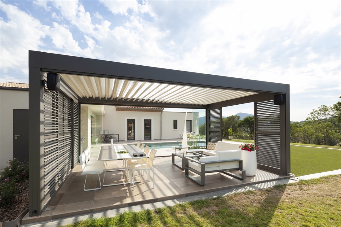 Freestanding Black Pergola With White Tilting Louvres In The Backyard Of A Modern Home 