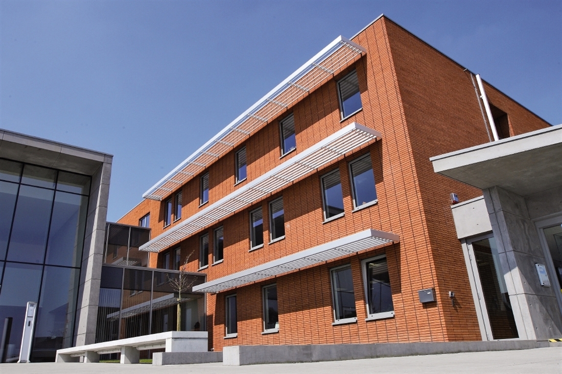 Red Brick Building with White Aluminum Brise Soleil Overhang above Windows on a Commercial Building