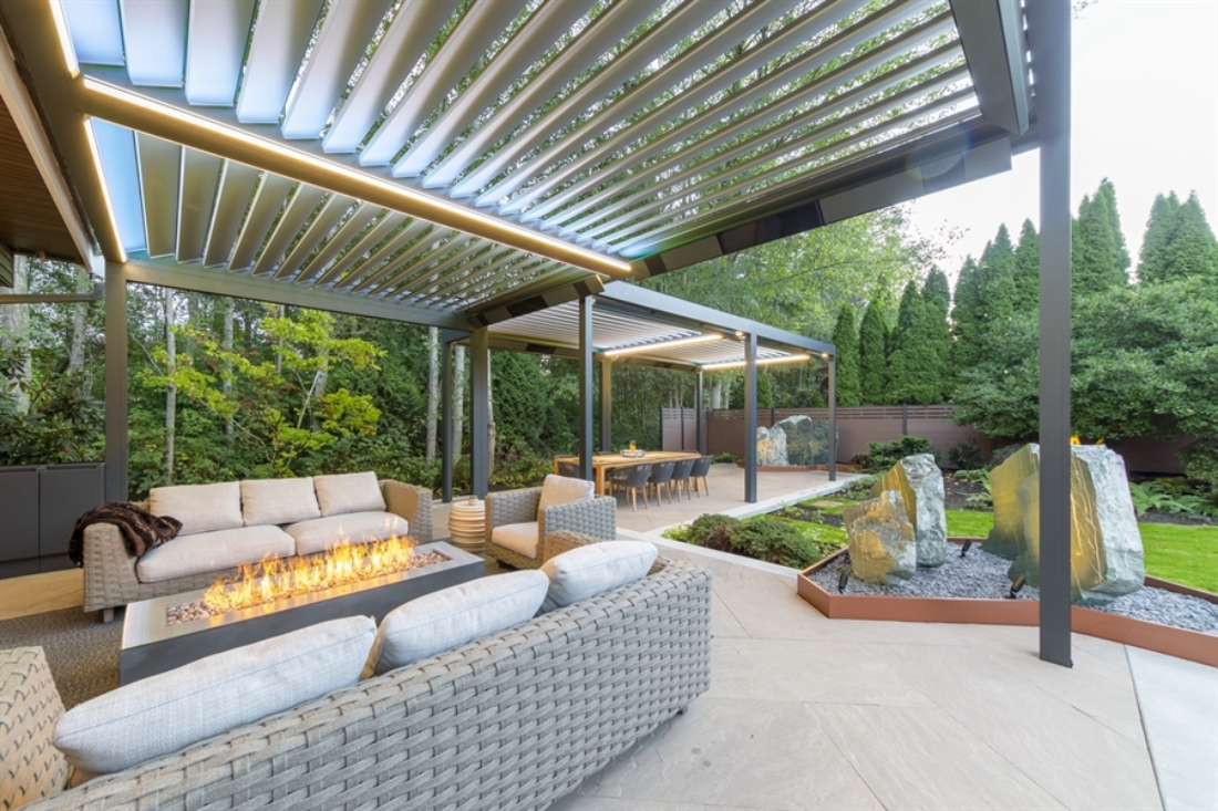 grey louvred bioclimatic pergolas attached to each other with lighting in a backyard