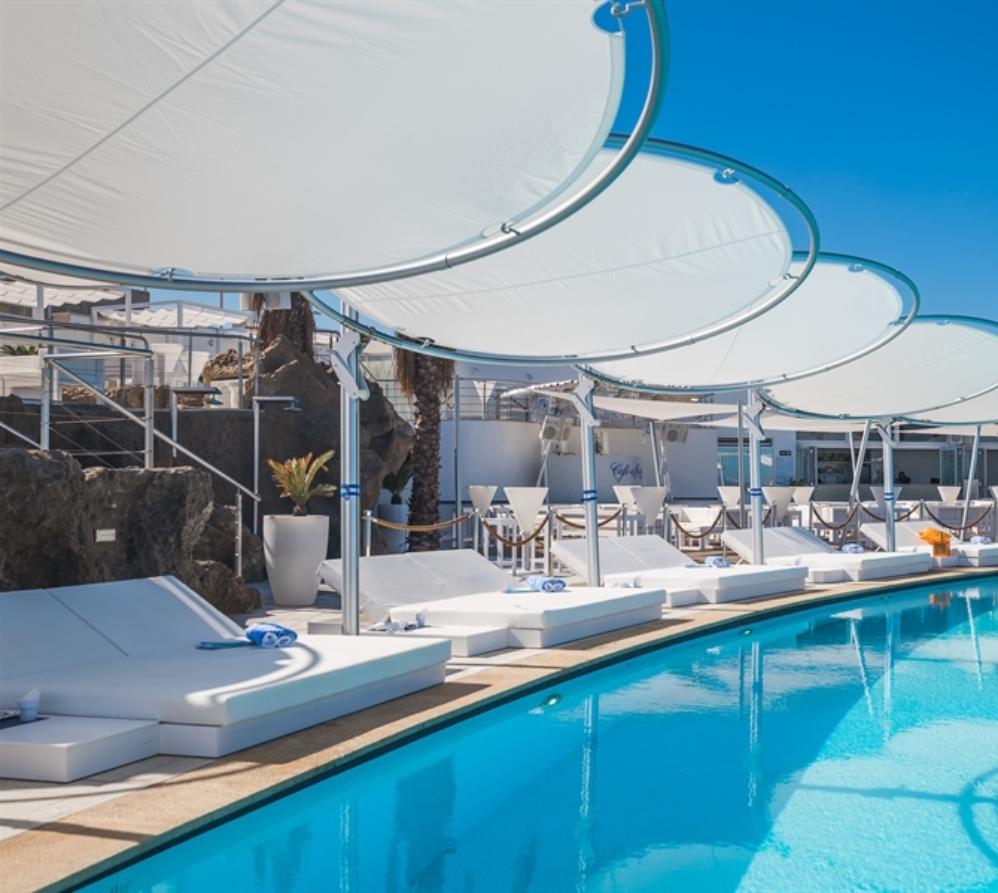 White Umbrosa Eclipsum umbrellas in a row poolside