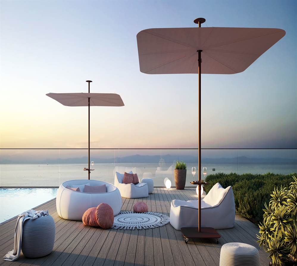 Cream coloured Umbrosa outdoor umbrellas poolside on a wooden deck overlooking the water 