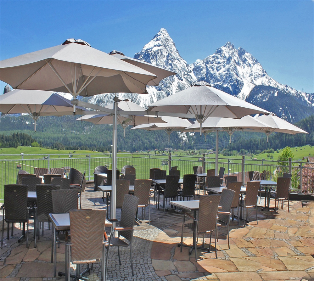 A series of multi umbrellas covering a commercial patio