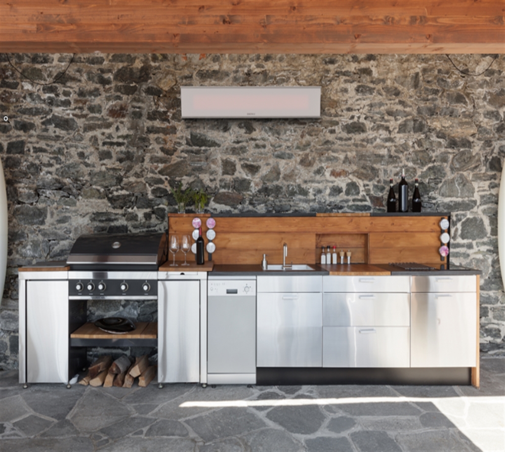 Contemporary patio kitchen setup with a sleek electric heater mounted on a stone wall.