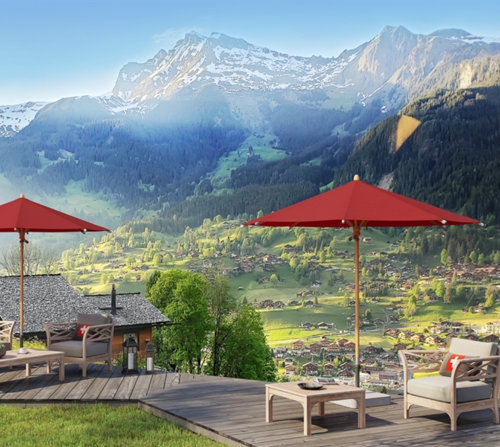 2 red umbrellas on a patio overlooking mountains