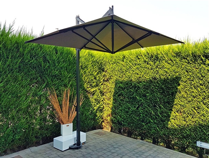 yellow patio umbrella sitting on pavers