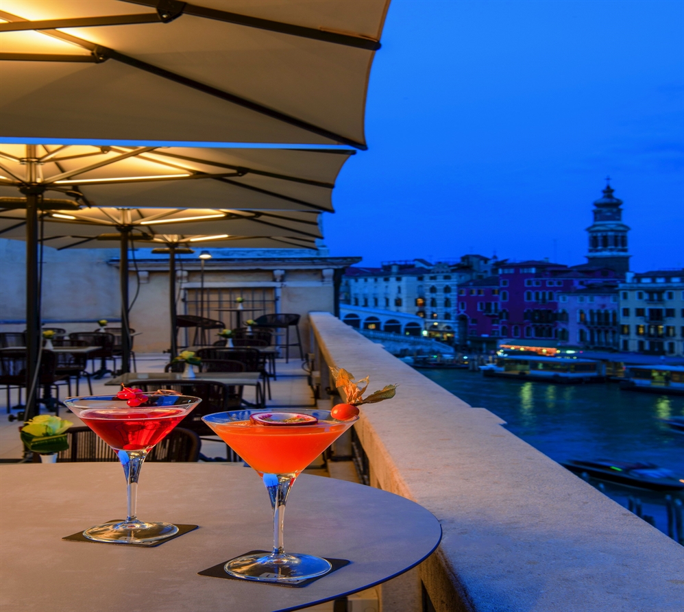 yellow patio umbrellas with led lighting strips covering a restaurant patio on the rooftop