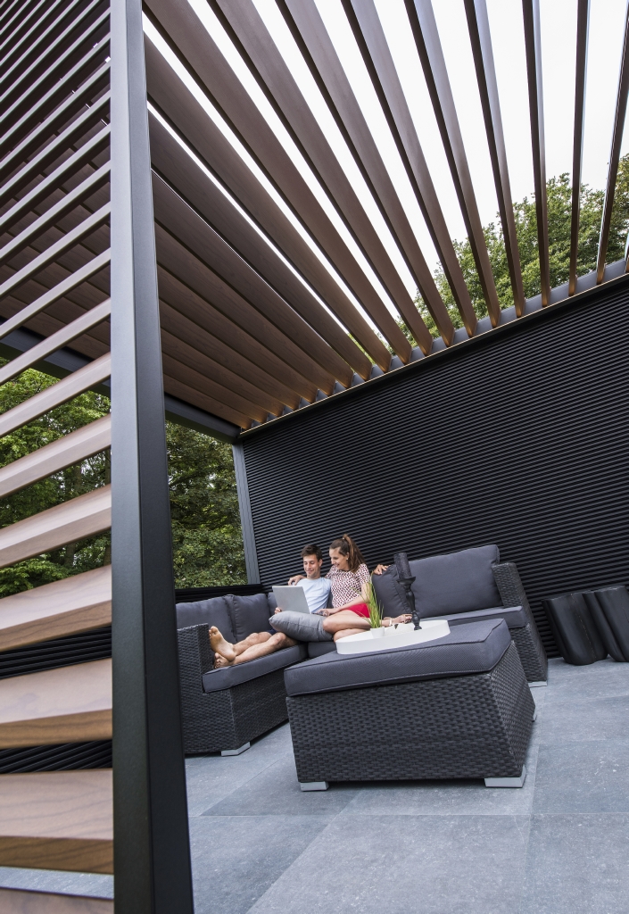 Linius black  aluminum wall cladding used as a half and full wall around a patio pergola perimeter