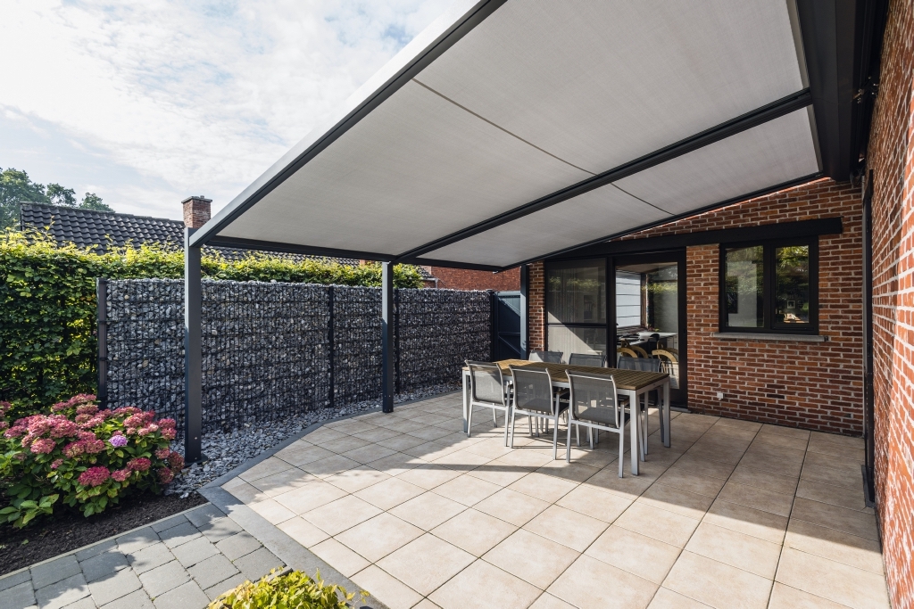 PVC retractable pergola above outdoor patio space PVC retractable pergola above outdoor patio space