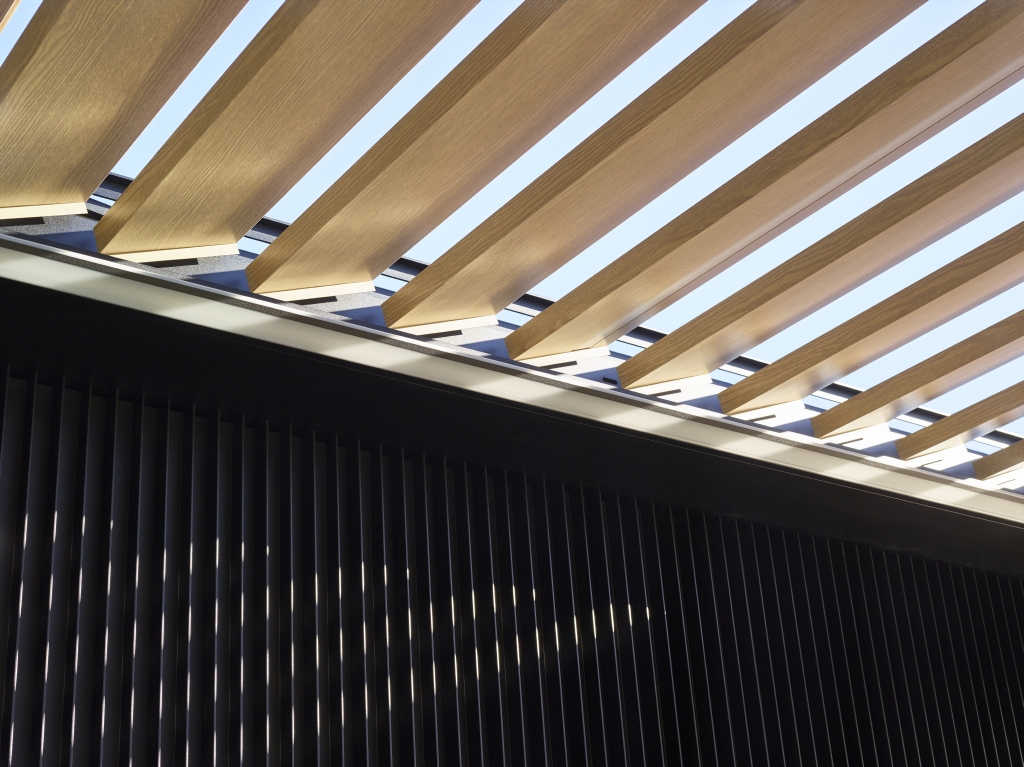 light brown wooden aluminum louvre option integrated in a pergola roof system