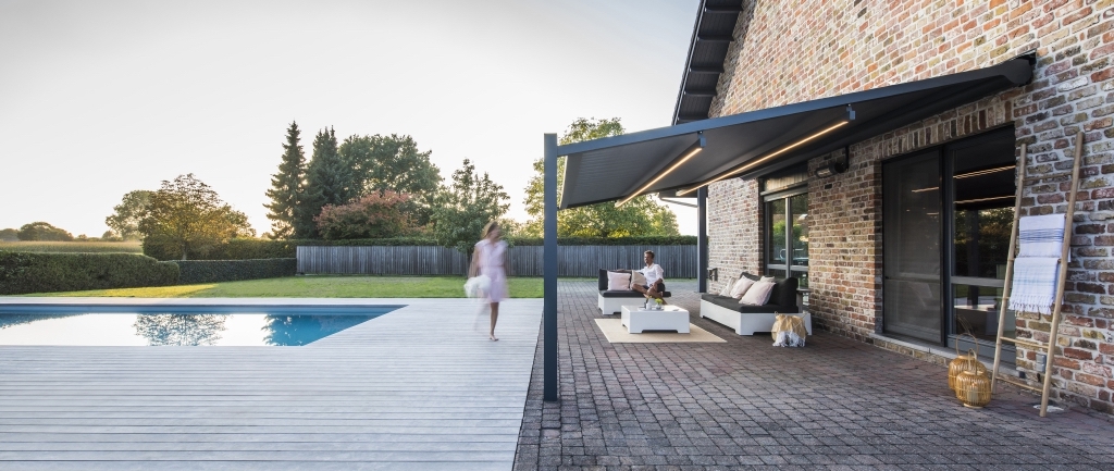 Couple at home poolside under a PVC pergola Couple at home poolside under a PVC pergola