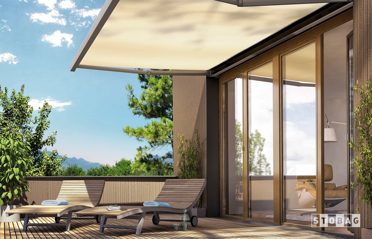 Beige arm bracket awning shaded patio chaise lounge chairs on patio
