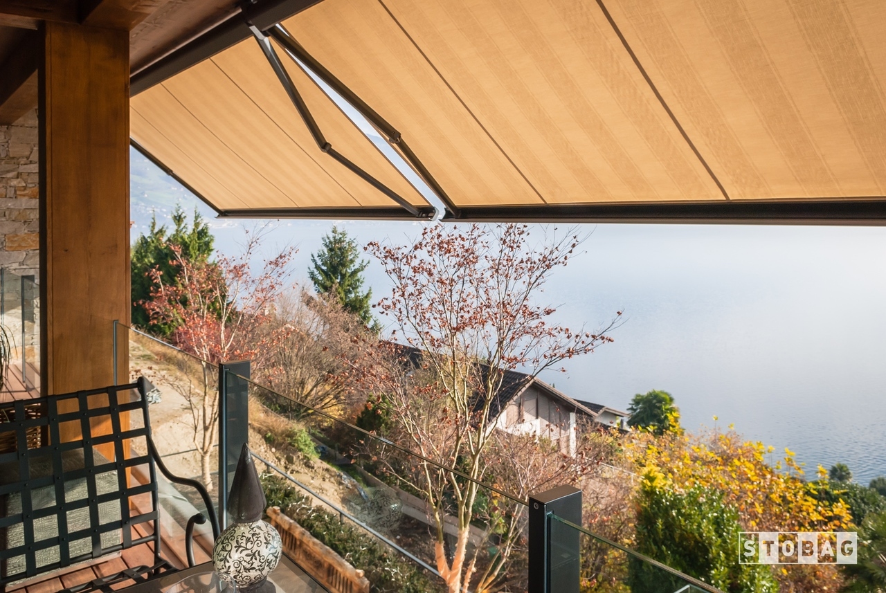 Arm bracket awnings extended at a sharp angel over a patio