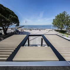 Black aluminum pergola with wood finish louvers tilted and retracted ocean front view