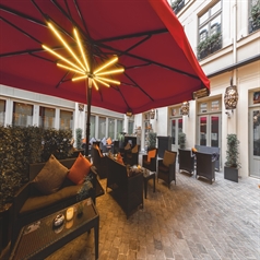 the underside of a red outdoor patio umbrella with led lighting strips on the frame