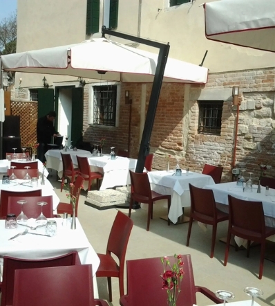 Pensile parasol over outdoor dining tables 