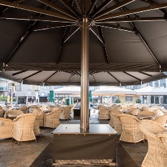 Underside view of two large Golia parasols over an outdoor cafe