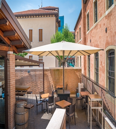 Cream parasol open and shading a restaurant patio