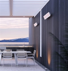 electric hearers white in colour attached to the wall of an outdoor patio area underneath a pergola