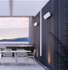 electric hearers white in colour attached to the wall of an outdoor patio area underneath a pergola