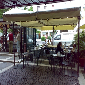 Cream parasols with detailed trim over patio area of restaurant