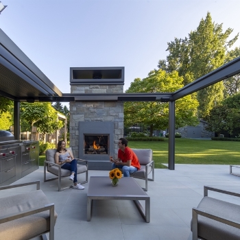 silver bioclimatic pergola with louvres open to sky above with people underneath