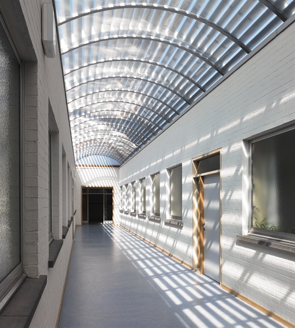 Aluminum louvres above an arched glass ceiling walkway to provide shade