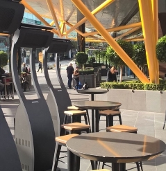 a series of portable heaters lined up at the outskirts of a patio