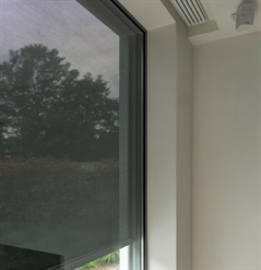 corner profile of an exterior mounted screen shown from the interior with a black fabric