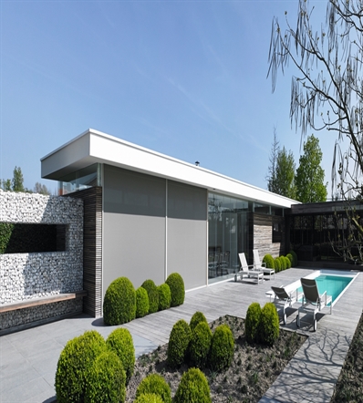 grey automated external blinds rolled all the way down installed on a residential home, poolside