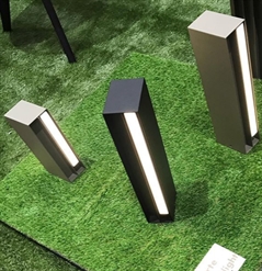 lighting products being displayed on fake grass at a tradeshow