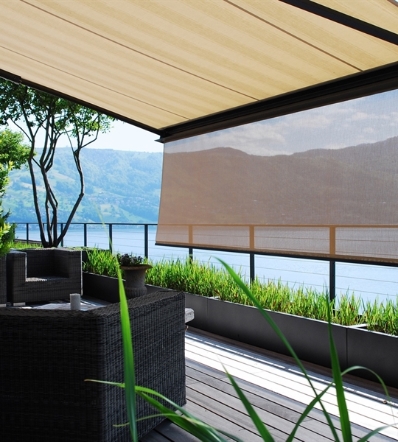 cream fabric retractable awning with a drop down screen overlooking the mountains