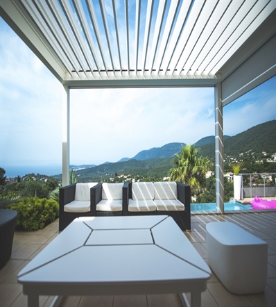 white aluminum louvred pergola on top of a residential patio, poolside, overlooking the mountains
