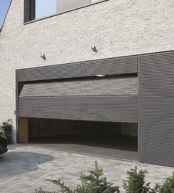 grey horizontal facade cladding covering a garage door of a home that is half open