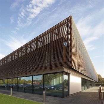 brown horizontal aluminum cladding in a unique pattern on the top half of a building