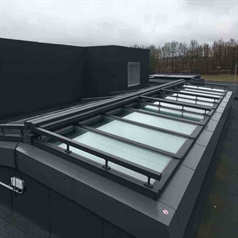 horizontal motorized screens atop a skylight window of a building fully retracted