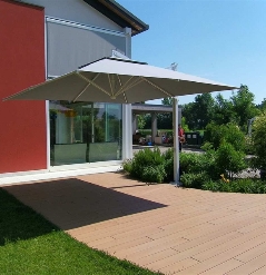 Gray parasol open and shading homes pathway