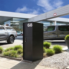 sleek black aluminum mailbox with unit number integrated at the entrance of a dealership