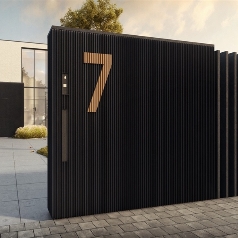 facade cladding covering an entry gate of a home with the house number engraved