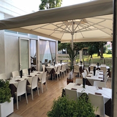 white umbrellas covering an outdoor patio area overlooking a field