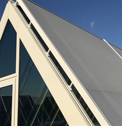 close up of grey external screen installed on the exterior of rooftop windows on a building