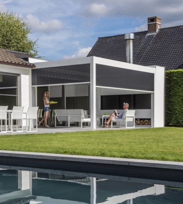 White aluminum pergola over home patio seating area with fixscreens partially drawn down on sides