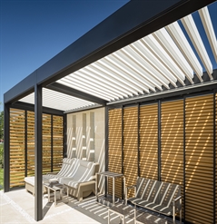 black aluminum panels with wodden style louvres integrated into a pergola for shading and privacy