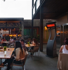 portable outdoor heater turned on heating a restaurant patio