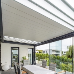 White pergola with aluminum louvers has glass translucent blades in louvers.