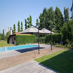 Two gray side arm parasols providing shade poolside