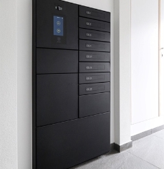 example of a series of aluminum mailboxes for an apartment complex, installed on a white wall