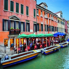 Parasols covering outdoor dining area along canal