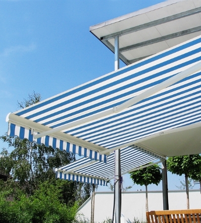 Blue and white stripped large awning covering outdoor deck area